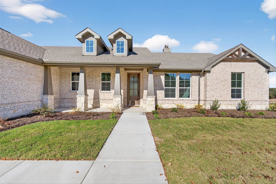 Front exterior of a new home in Oak Grove Addition, Springtown, TX, highlighting curb appeal (Image 27).