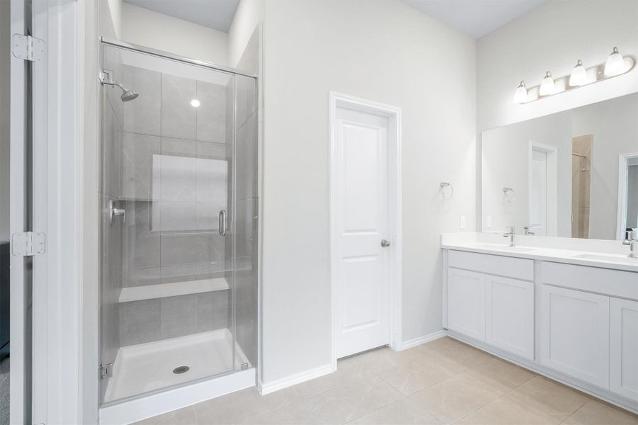 And there is the walk-in shower. Glass door, tiled walls, and a built-in bench, paired with the double vanity and soaking tub from the other side. The primary bath truly has it all. And there is the walk-in shower. Glass door, tiled walls, and a built-in bench, paired with the double vanity and soaking tub from the other side. The primary bath truly has it all.