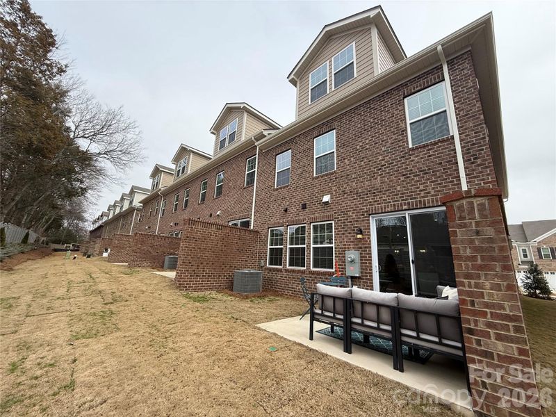 Exterior details and patio area of a home in The Townes at Wade Ardrey, Charlotte (Image 2). Exterior details and patio area of a home in The Townes at Wade Ardrey, Charlotte (Image 2).