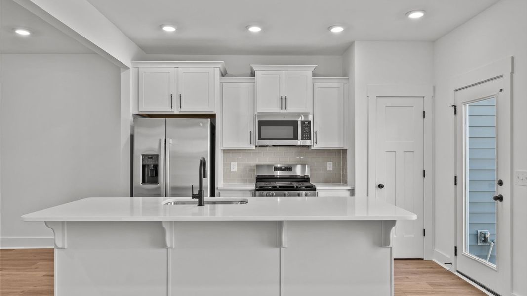 Notable 9-foot island provides generous prep and gathering space in this thoughtfully designed kitchen