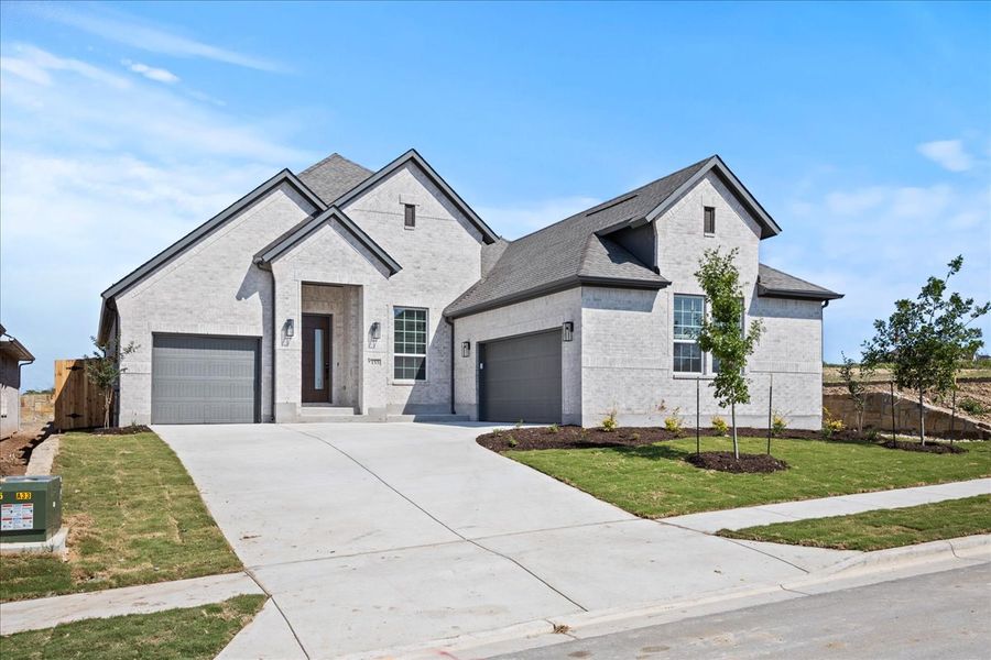 Representative exterior photo of a completed home built from the Farris by Chesmar Homes in Sunfield, Buda, TX (Image 2).
