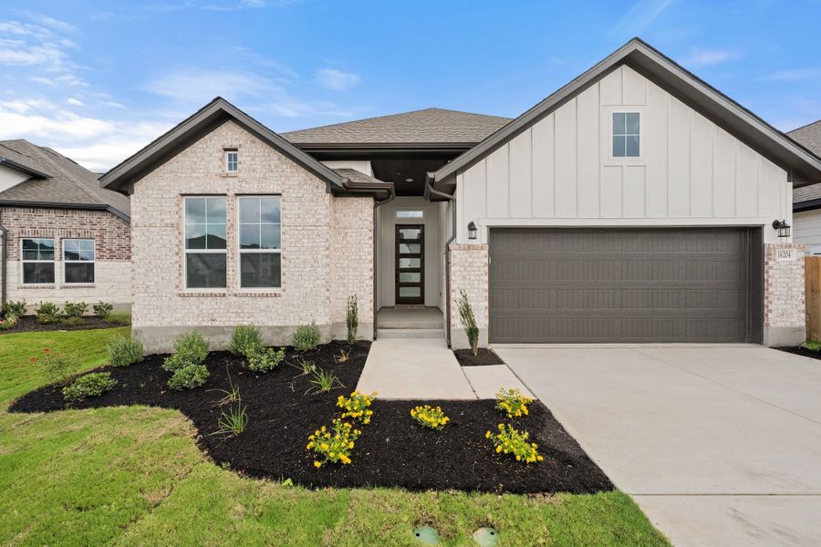 Front exterior of a new home in Lagos Reserve, Manor, TX, highlighting curb appeal (Image 25).