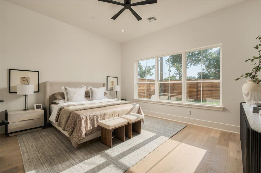 The primary suite offers impressive scale and abundant natural light, creating a serene retreat with ample room for a dedicated sitting area.
