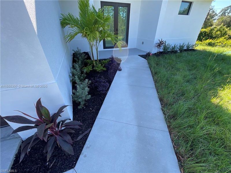 Front exterior of a new home in , Lehigh Acres, FL, highlighting curb appeal (Image 2). Front exterior of a new home in , Lehigh Acres, FL, highlighting curb appeal (Image 2).