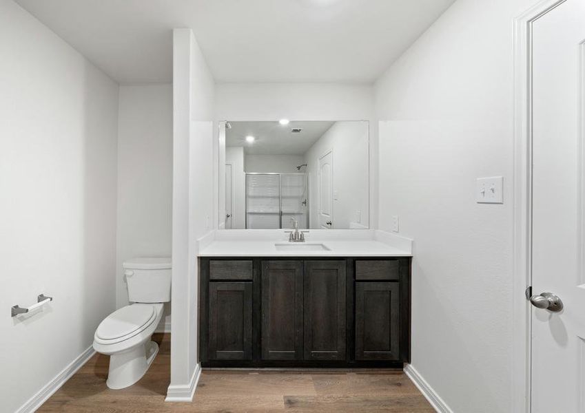 The master bathroom has a spacious vanity space.