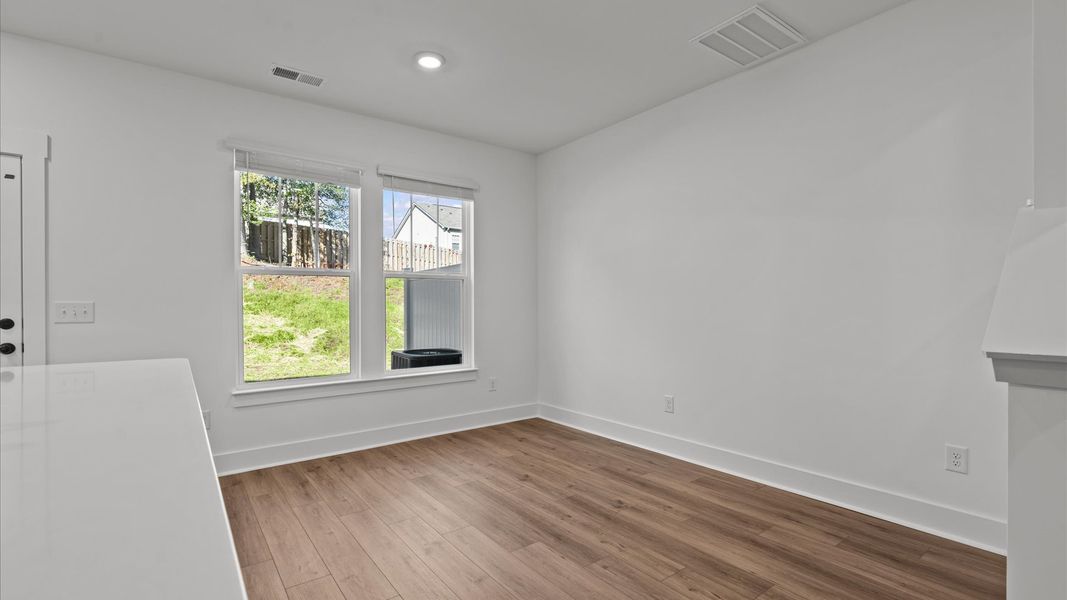 Elegant dining area opens to a functional floor plan with tasteful upgrades throughout
