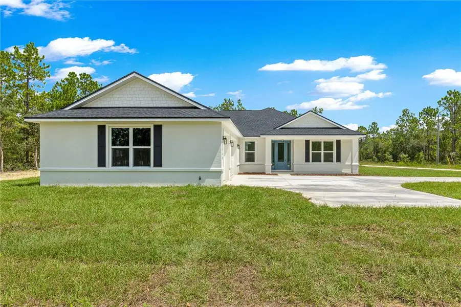 Front exterior of a new home in , Dunnellon, FL, highlighting curb appeal (Image 2).