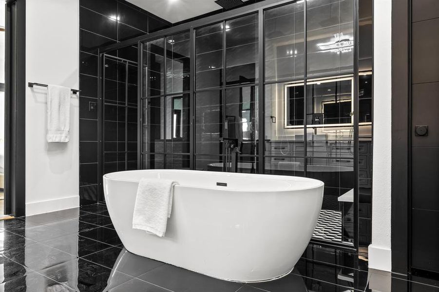 Full bathroom with a freestanding tub and tile walls