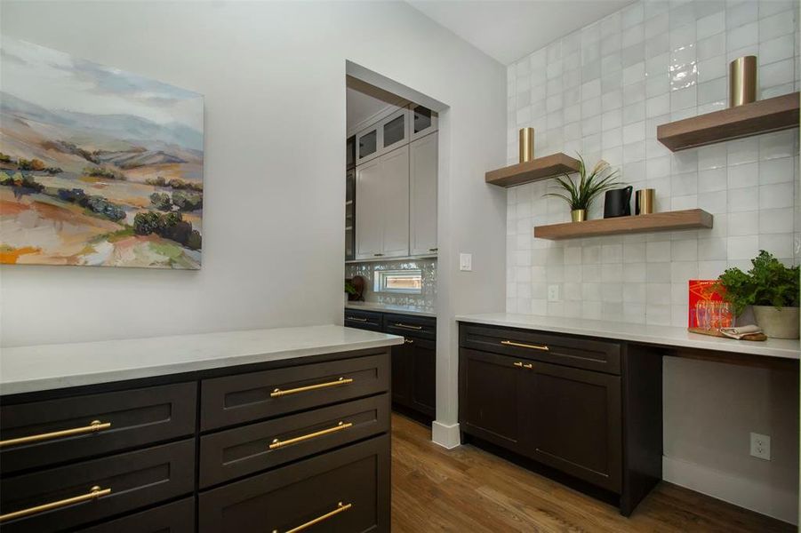 Kitchen with backsplash and dark wood-type flooring