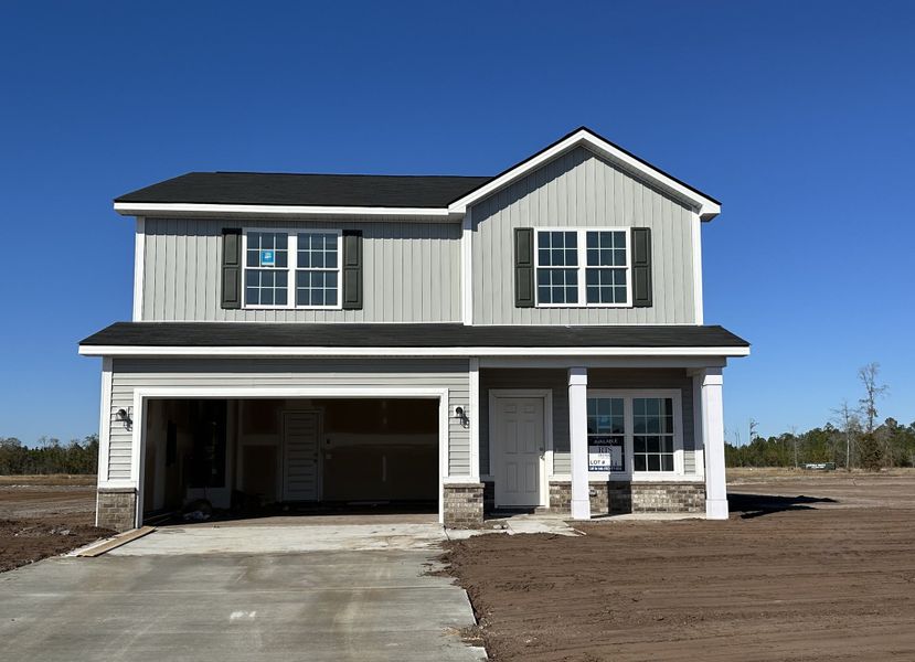 Front exterior of a new home in The Village at Sassafras, Allenhurst, GA, highlighting curb appeal (Image 1). Front exterior of a new home in The Village at Sassafras, Allenhurst, GA, highlighting curb appeal (Image 1).