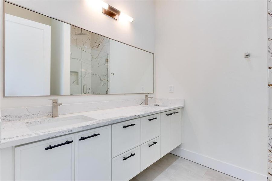 Bathroom with vanity and a shower with door