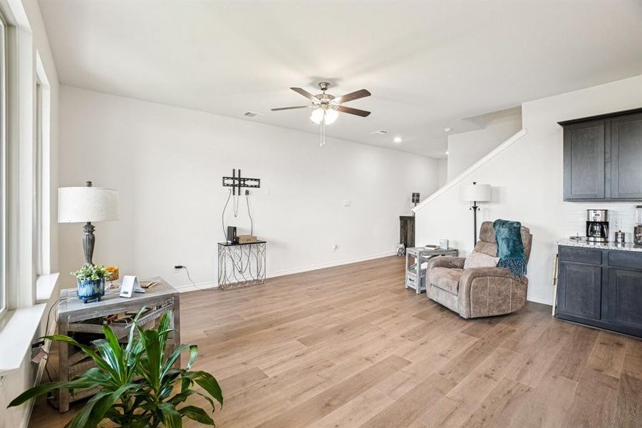 Sitting room with light wood-style floors, ceiling fan, and recessed lighting Sitting room with light wood-style floors, ceiling fan, and recessed lighting