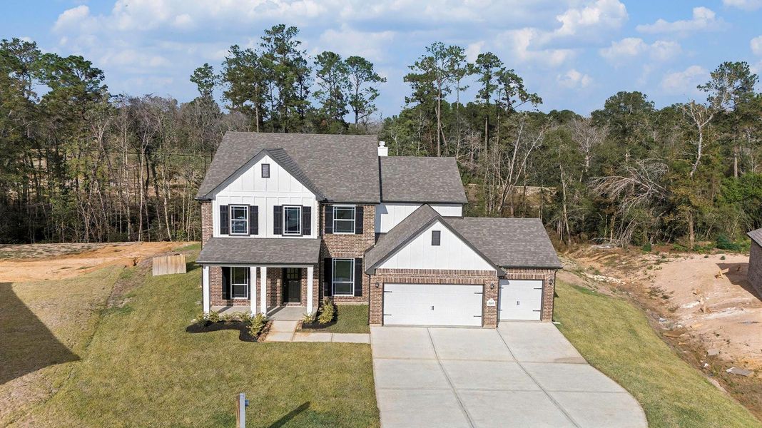Front exterior of a new home in Oakwood Ranch, Willis, TX, highlighting curb appeal (Image 17).