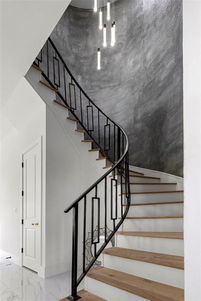 Unique Staircase with ornate light fixture