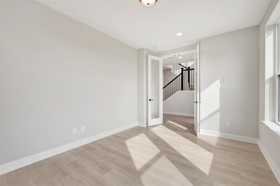 Spare room featuring light wood-type flooring and recessed lighting