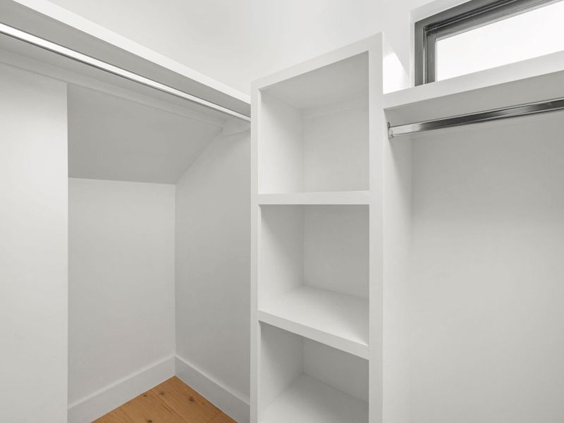 Spacious closet with light wood finished floors