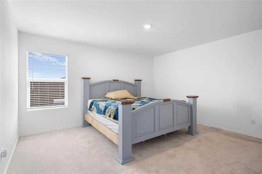 Spacious room featuring neutral carpeting and white walls Spacious room featuring neutral carpeting and white walls