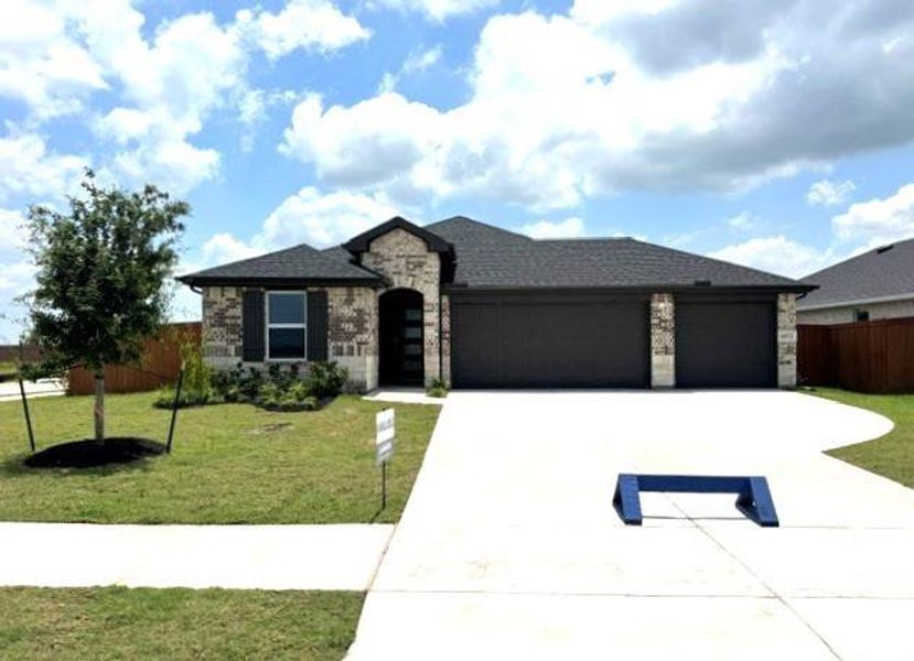 Front exterior of a new home in Sunterra Lakes, Brookshire, TX, highlighting curb appeal (Image 1). Front exterior of a new home in Sunterra Lakes, Brookshire, TX, highlighting curb appeal (Image 1).