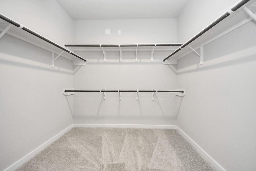 Walk-in closet that epitomizes luxury and practicality. This generously sized space features built-in shelving, offering abundant room for impeccable organization. High ceilings and recessed lighting create a bright and welcoming ambiance. Walk-in closet that epitomizes luxury and practicality. This generously sized space features built-in shelving, offering abundant room for impeccable organization. High ceilings and recessed lighting create a bright and welcoming ambiance.