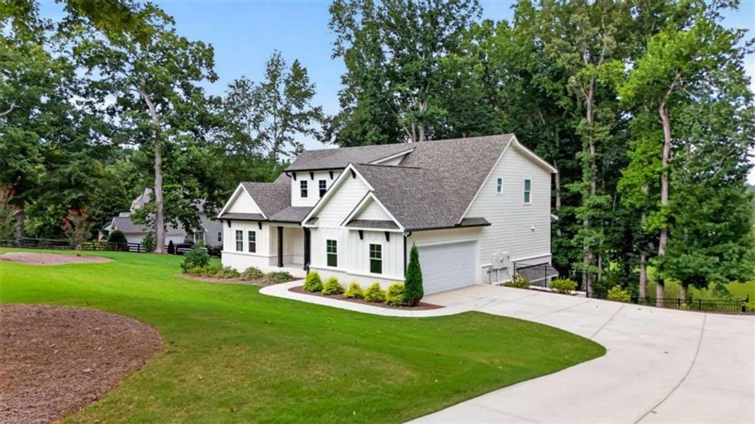 Front exterior of a new home in , Hoschton, GA, highlighting curb appeal (Image 34).