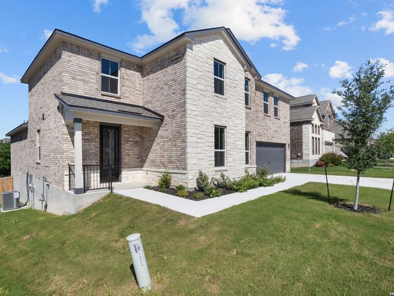 Front exterior of a new home in Ladera, San Antonio, TX, highlighting curb appeal (Image 2).