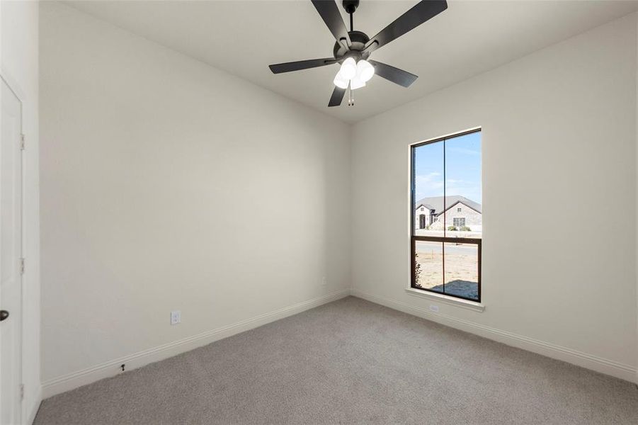 Unfurnished room featuring light carpet and ceiling fan Unfurnished room featuring light carpet and ceiling fan