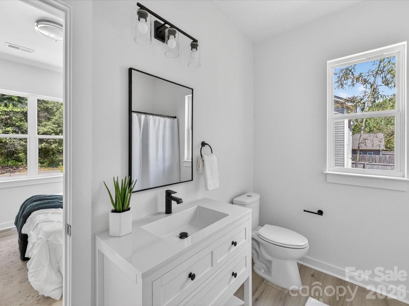 Primary suite bathroom features sleek modern finishes, a spacious layout, designed for everyday comfort and style.