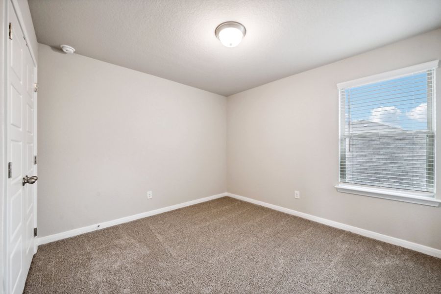 Guest bedroom in the Reynolds floorplan at a Meritage Homes community.