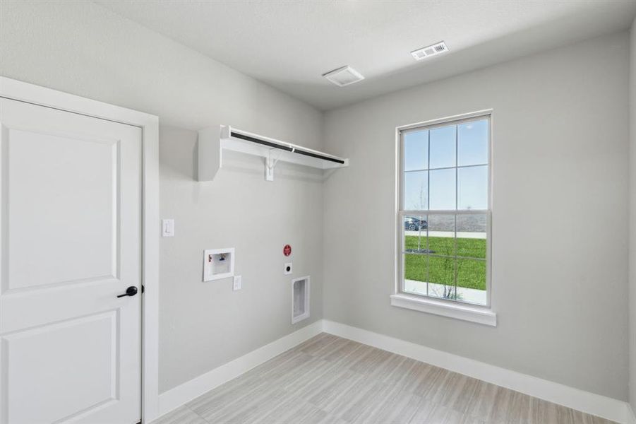 Washroom with visible vents, laundry area, hookup for a washing machine, hookup for a gas dryer, and hookup for an electric dryer