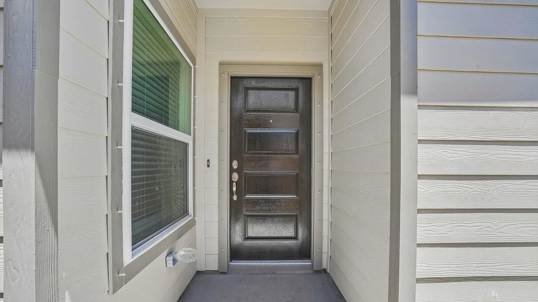 Exterior details and patio area of a home in Meridiana Townhomes, Iowa Colony (Image 3).