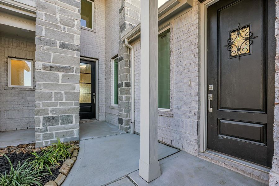 Front Entry: A sheltered approach framed by brick and stone creates a quiet sense of arrival. The private Next Gen entrance and main entry are thoughtfully positioned, offering choice, separation, and a welcoming first impression. Front Entry: A sheltered approach framed by brick and stone creates a quiet sense of arrival. The private Next Gen entrance and main entry are thoughtfully positioned, offering choice, separation, and a welcoming first impression.