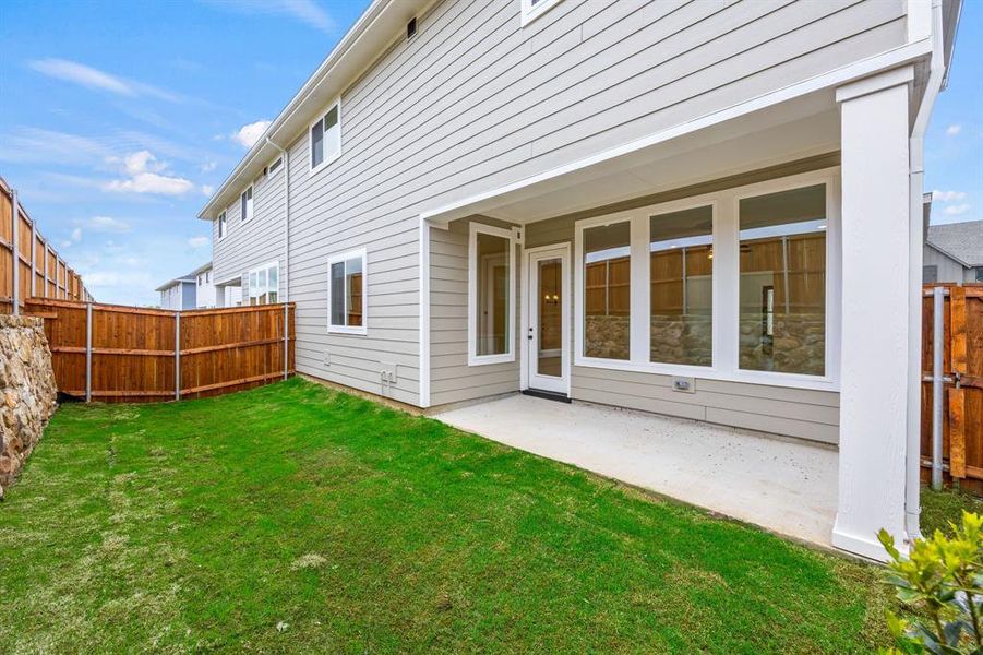 Exterior details and patio area of a home in North Square at Uptown, Celina (Image 21).