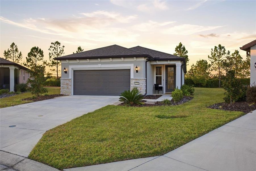 Front exterior of a new home in Del Webb Stone Creek, Ocala, FL, highlighting curb appeal (Image 23). Front exterior of a new home in Del Webb Stone Creek, Ocala, FL, highlighting curb appeal (Image 23).