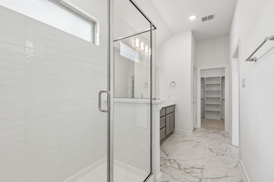 Primary Bathroom in the Claret home plan by Trophy Signature Homes – REPRESENTATIVE PHOTO