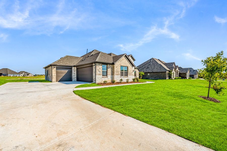 Front exterior of a new home in Creekview Farms, Greenville, TX, highlighting curb appeal (Image 24).