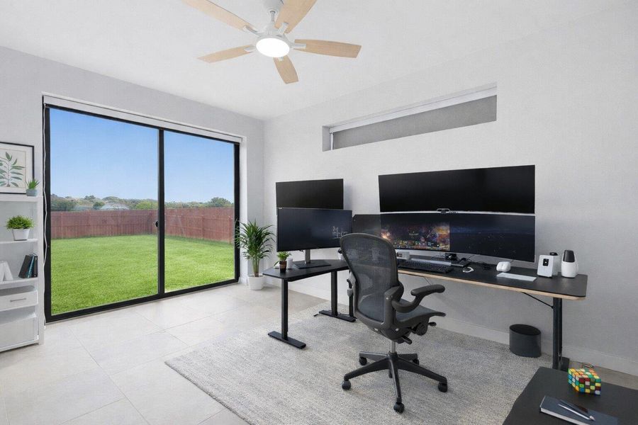 Office space with ceiling fan and baseboards