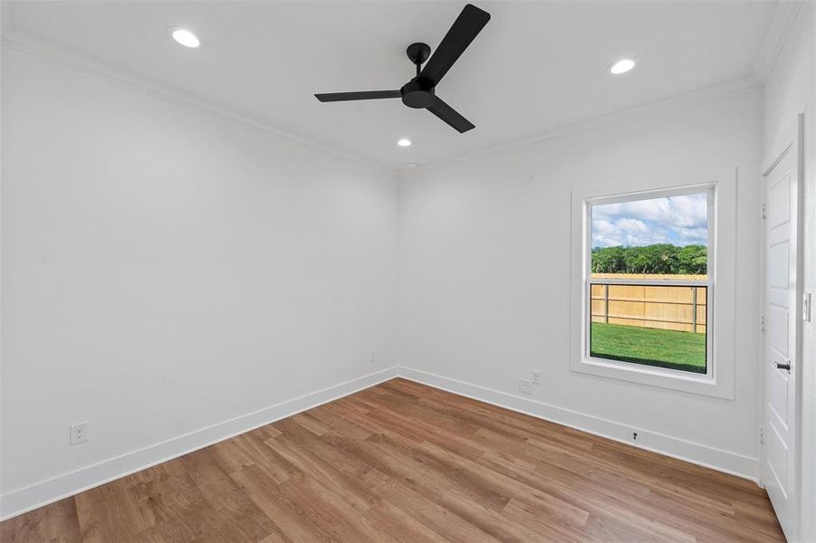 Unfurnished room featuring crown molding, ceiling fan, light wood-type flooring, and recessed lighting