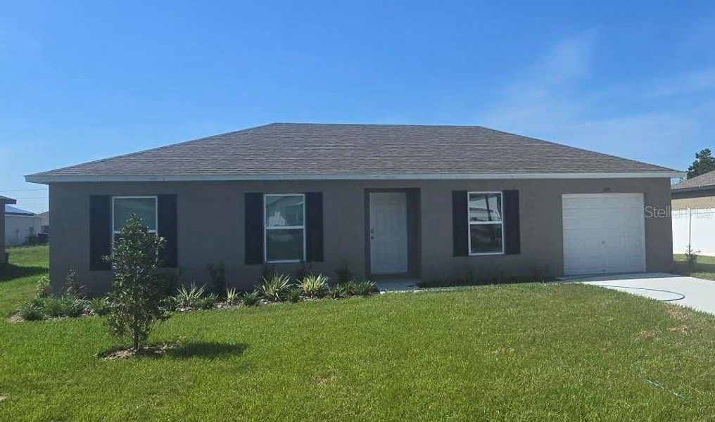 Front exterior of a new home in Poinciana, Poinciana, FL, highlighting curb appeal (Image 1).
