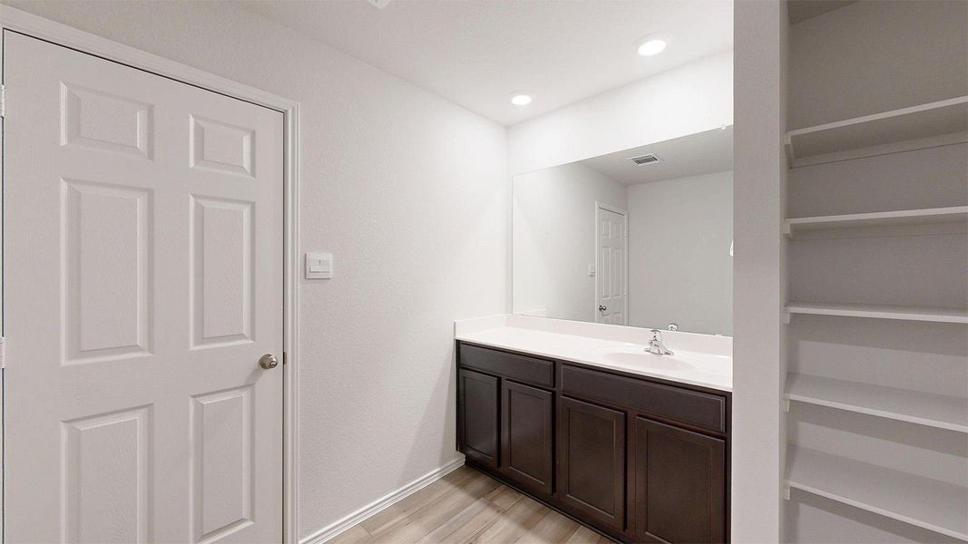 Bathroom featuring vanity and light wood-style flooring