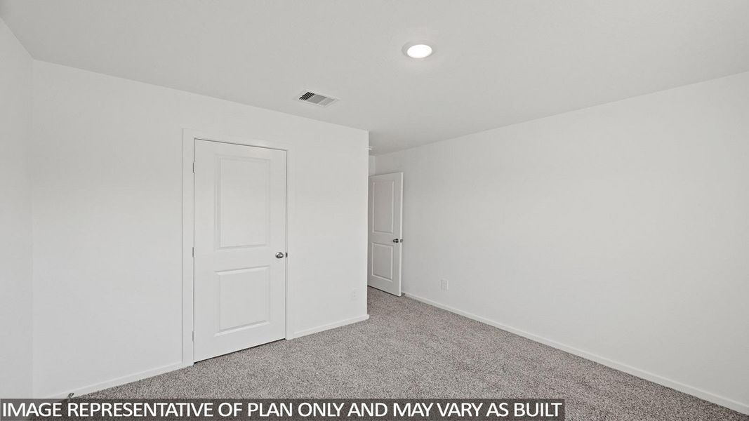 Unfurnished bedroom featuring light colored carpet and baseboards