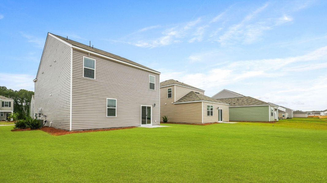Exterior details and patio area of a home in Pine Hills at Cane Bay, Moncks Corner (Image 17).