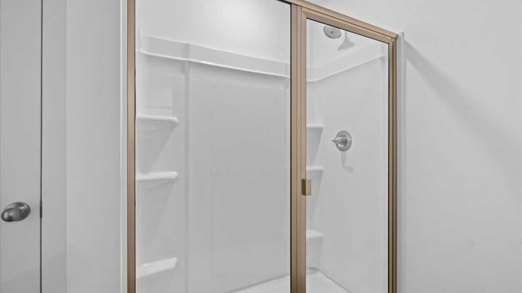 Accomplished design shines in this primary bath with a sleek walk-in shower near Downtown Simpsonville