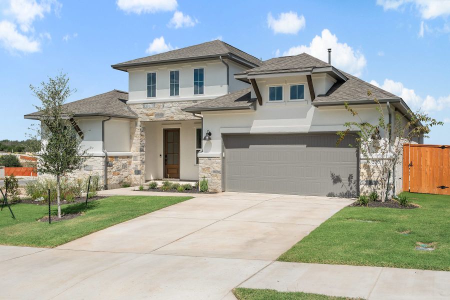 Front exterior of a new home in Lariat, Liberty Hill, TX, highlighting curb appeal (Image 22).