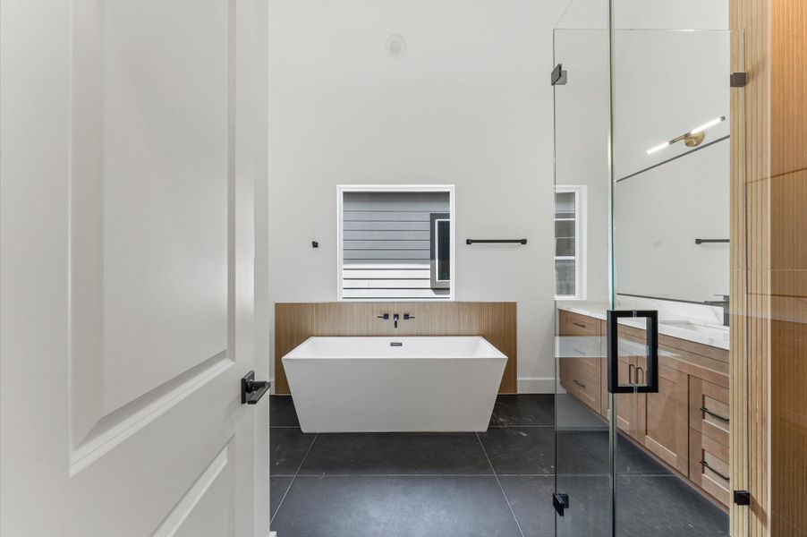 Step into the spacious primary bathroom for a relaxing experience.