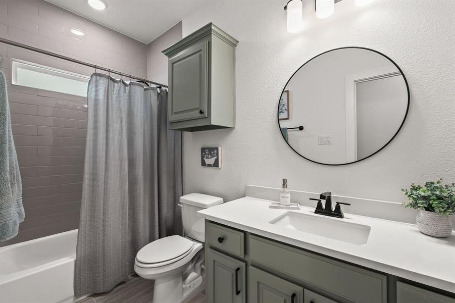 Full bath with shower / bath combo, vanity, and a textured wall Full bath with shower / bath combo, vanity, and a textured wall