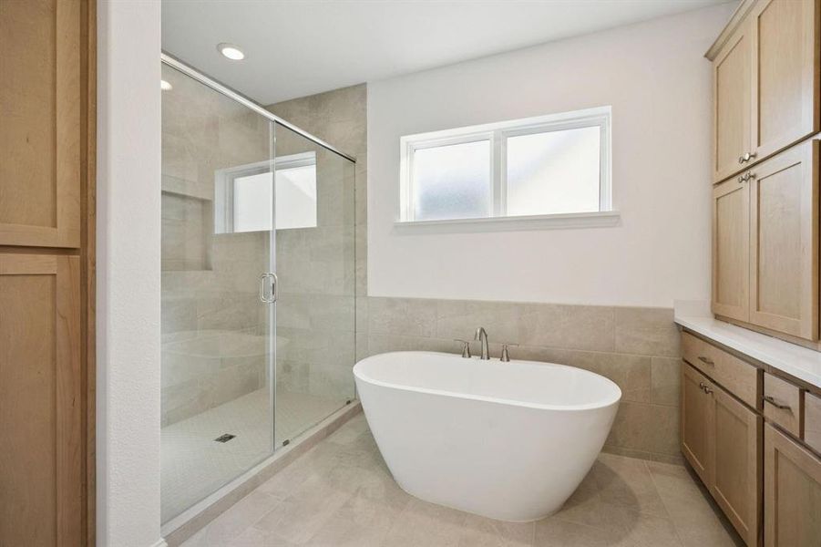 Full bath featuring a soaking tub, a stall shower, tile walls, a wainscoted wall, and recessed lighting Full bath featuring a soaking tub, a stall shower, tile walls, a wainscoted wall, and recessed lighting