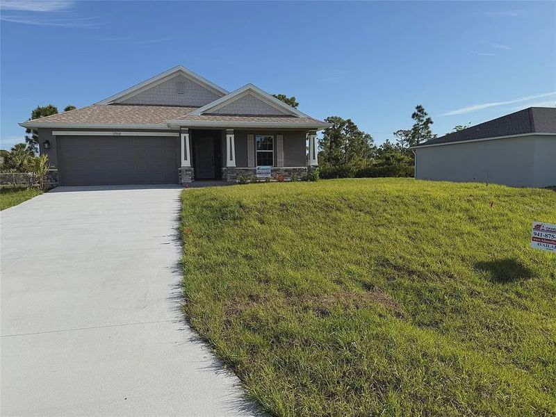 Front exterior of a new home in Gulf Cove, Port Charlotte, FL, highlighting curb appeal (Image 6). Front exterior of a new home in Gulf Cove, Port Charlotte, FL, highlighting curb appeal (Image 6).