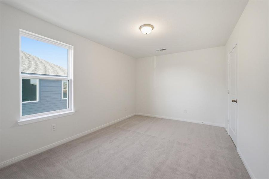 Carpeted room featuring a single window, white trim, and a flush-mount ceiling light fixture