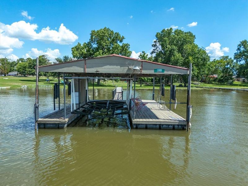 Dock area with boat lift and a water view Dock area with boat lift and a water view
