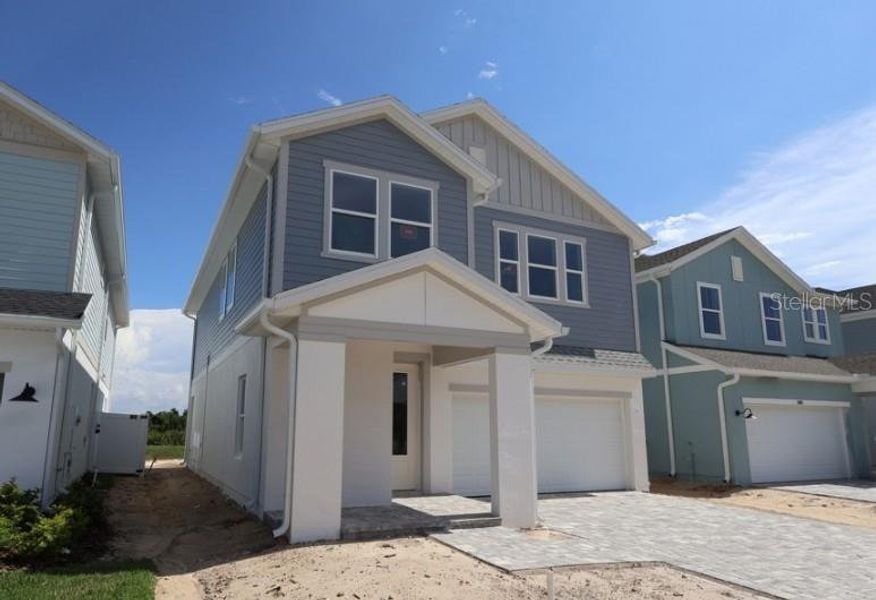 Front exterior of a new home in Persimmon Place – Garden Series, Wesley Chapel, FL, highlighting curb appeal (Image 7). Front exterior of a new home in Persimmon Place – Garden Series, Wesley Chapel, FL, highlighting curb appeal (Image 7).